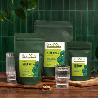 All three sizes of Gotu Kola pouches on a wooden surface with a green tiled wall background.