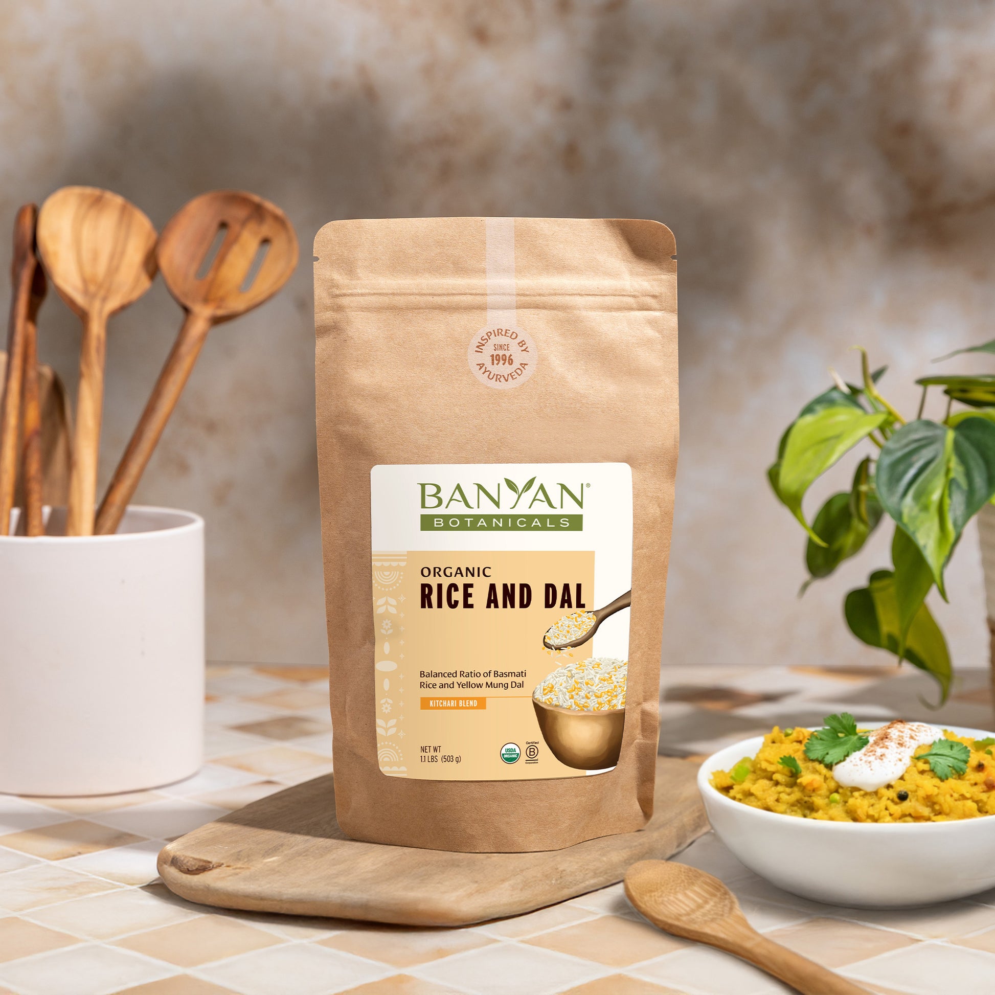 Banyan Botanicals Organic Rice and Dal package on a kitchen counter with a bowl of kitchari.
