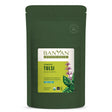 Green pouch of Banyan Botanicals Tulsi powder on a white background