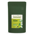 Green pouch of Banyan Botanicals Vasaka powder on a white background